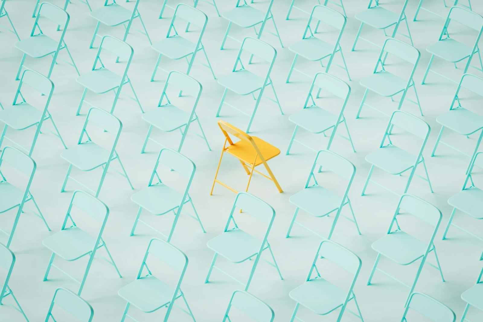 Yellow chair standing out among rows of pale blue chairs, representing KYC brand differentiation and trust in the UAE financial services market.