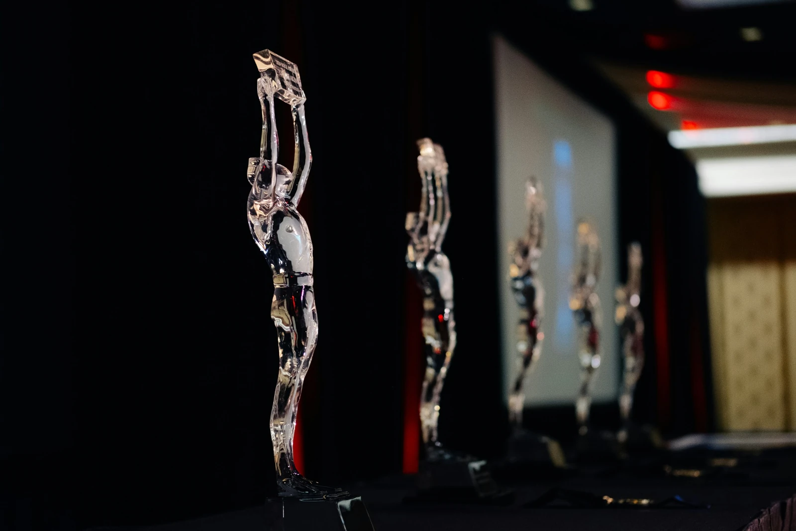 Glass award trophies displayed on stage at an annual energy awards event.